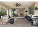 Covered patio with ceiling fan and access to the home's interior, with a grill and patio furniture at 3218 Mura Del Prato Ave, Henderson, NV 89044