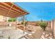 View of a spacious backyard with covered patio and rock landscaping at 3448 Quiet Pueblo St, North Las Vegas, NV 89032