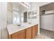 Bathroom showcasing a double sink vanity with mirrors and access to a walk-in closet at 3448 Quiet Pueblo St, North Las Vegas, NV 89032