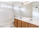 Bright bathroom featuring a double sink vanity, and a shower-tub combo with tiled walls at 3448 Quiet Pueblo St, North Las Vegas, NV 89032