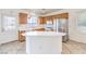 Bright kitchen boasting an island, stainless steel appliances, and tile flooring at 3448 Quiet Pueblo St, North Las Vegas, NV 89032