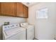 Bright laundry room with cabinets, window, and washer and dryer at 3448 Quiet Pueblo St, North Las Vegas, NV 89032