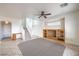 Open-concept living room with staircase, entertainment center, and tile flooring at 3448 Quiet Pueblo St, North Las Vegas, NV 89032