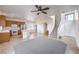 Spacious open-concept living room with tile flooring, kitchen, and staircase at 3448 Quiet Pueblo St, North Las Vegas, NV 89032
