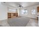 Cozy living room featuring tile floors, an entertainment center, and natural light at 3448 Quiet Pueblo St, North Las Vegas, NV 89032