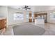 Bright living room showcasing a kitchen, tile floors, ceiling fan, and natural light at 3448 Quiet Pueblo St, North Las Vegas, NV 89032