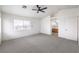 Spacious main bedroom featuring a ceiling fan, plush carpeting, and access to the ensuite bathroom at 3448 Quiet Pueblo St, North Las Vegas, NV 89032