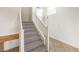 Carpeted stairs with white banister at 3448 Quiet Pueblo St, North Las Vegas, NV 89032