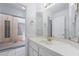Well-lit bathroom featuring a large mirror, modern fixtures, and a vanity area at 3594 Wild Cherry Ct, Las Vegas, NV 89121