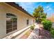 Exterior view of home featuring decorative windows and a landscaped walkway and lush landscaping at 3594 Wild Cherry Ct, Las Vegas, NV 89121