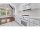 Modern kitchen features white cabinets, tile countertops, and stainless steel appliances at 3594 Wild Cherry Ct, Las Vegas, NV 89121