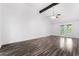 Open living room featuring beautiful hardwood floors, vaulted ceilings, and large windows for natural light at 3594 Wild Cherry Ct, Las Vegas, NV 89121