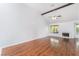 Living room with hardwood flooring, white walls, vaulted ceilings, and fireplace at 3594 Wild Cherry Ct, Las Vegas, NV 89121