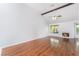 Living room with hardwood flooring, white walls, vaulted ceilings, and fireplace at 3594 Wild Cherry Ct, Las Vegas, NV 89121