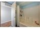 Bright bathroom featuring a shower over bath, with a clear shower curtain and tiled walls at 3642 Haverhill St, Las Vegas, NV 89121