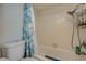 Bathroom featuring a toilet and shower with blue patterned shower curtain and tiled walls at 3642 Haverhill St, Las Vegas, NV 89121