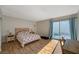 Bedroom with wood-look flooring, a bed, and sliding glass doors to the outside patio at 3642 Haverhill St, Las Vegas, NV 89121