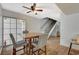 The dining area features stairs to the second floor, wood floors, and a ceiling fan at 3642 Haverhill St, Las Vegas, NV 89121