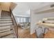 Open-concept living area with staircase, modern furniture, and kitchen view at 3642 Haverhill St, Las Vegas, NV 89121