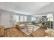 Bright living room featuring a staircase, and door, complemented by hardwood floors, and a full-wall mirror at 3642 Haverhill St, Las Vegas, NV 89121