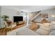 Bright living room featuring a staircase, and dining area, complemented by hardwood floors, and a full-wall mirror at 3642 Haverhill St, Las Vegas, NV 89121