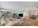 Bright living room featuring a staircase, and dining area, complemented by hardwood floors, and a full-wall mirror at 3642 Haverhill St, Las Vegas, NV 89121