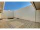 Private tiled patio with a small green space and enclosed walls at 3642 Haverhill St, Las Vegas, NV 89121