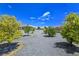 Gravel backyard with trees and view of house, gazebo and mountains in the distance at 3780 Shawnee Ave, Pahrump, NV 89048