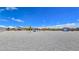 A large gravel backyard features a gazebo, carport, shed, and diverse desert foliage at 3780 Shawnee Ave, Pahrump, NV 89048