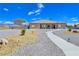 Expansive backyard featuring gravel landscaping and a charming walkway leading to the home at 3780 Shawnee Ave, Pahrump, NV 89048