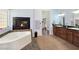 Luxurious bathroom with a fireplace, soaking tub, and double sink vanity at 3780 Shawnee Ave, Pahrump, NV 89048