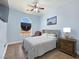 Charming bedroom featuring a ceiling fan, neutral color palette, and an arched window providing natural light at 3780 Shawnee Ave, Pahrump, NV 89048