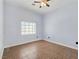 Bright bedroom featuring tile flooring, a ceiling fan, and a window providing natural light at 3780 Shawnee Ave, Pahrump, NV 89048