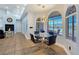 Charming dining area with large arched windows offering serene views and a stylish modern chandelier above at 3780 Shawnee Ave, Pahrump, NV 89048