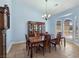 Dining room with a large dining table, china cabinet, and bay window providing plenty of natural light at 3780 Shawnee Ave, Pahrump, NV 89048