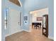 Inviting entryway with tile flooring, a bright front door, and an archway leading to a piano room at 3780 Shawnee Ave, Pahrump, NV 89048