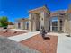 Covered entryway with a water fountain and statue, enhanced by the manicured desert landscaping at 3780 Shawnee Ave, Pahrump, NV 89048