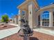 Close-up of a statue water fountain at the home's entrance, framed by arched windows at 3780 Shawnee Ave, Pahrump, NV 89048
