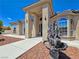 Grand entrance with a decorative water fountain and statues, framed by desert landscaping at 3780 Shawnee Ave, Pahrump, NV 89048
