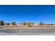 Expansive single-story home showcasing desert landscaping, circular driveway, and a symmetrical facade under a clear blue sky at 3780 Shawnee Ave, Pahrump, NV 89048