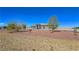 Desert-landscaped front yard featuring decorative rocks, native plants, and a view of the home's facade at 3780 Shawnee Ave, Pahrump, NV 89048