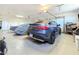 Organized garage with a sleek gray Mercedes-Benz and covered vehicle at 3780 Shawnee Ave, Pahrump, NV 89048
