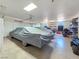Spacious garage with multiple vehicles, including cars, a motorcycle, and an ATV at 3780 Shawnee Ave, Pahrump, NV 89048