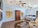 Spacious main bedroom suite featuring a fireplace, sitting area, and two ceiling fans at 3780 Shawnee Ave, Pahrump, NV 89048