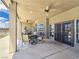 Covered patio with outdoor dining, fan and views of the landscaped backyard at 3780 Shawnee Ave, Pahrump, NV 89048
