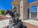 Detailed water fountain statue in front of a stucco home with arched windows and desert landscaping at 3780 Shawnee Ave, Pahrump, NV 89048