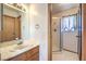 Bathroom with a single sink vanity and glass shower at 403 Woodridge Dr, Henderson, NV 89015