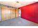The second bedroom has a large closet and brightly painted red wall at 403 Woodridge Dr, Henderson, NV 89015