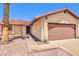 Well-maintained single-story house featuring a tile roof, gravel landscaping, and a two-car garage at 403 Woodridge Dr, Henderson, NV 89015