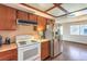Kitchen with stainless steel refrigerator, white stove and view to living room at 403 Woodridge Dr, Henderson, NV 89015
